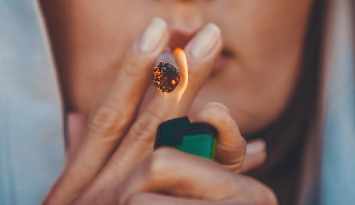 Young Woman Lighting a Joint