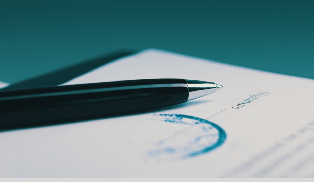 A large image of a pen signing an important document and warning letters issued by the FDA regarding cannabinoid products