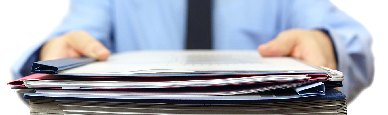 Person handing over a stack of documents