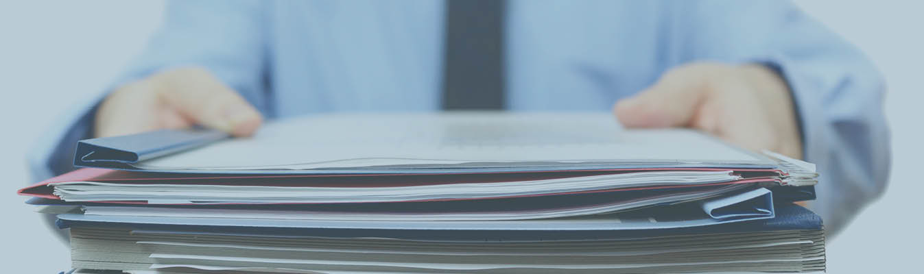 Person handing over a stack of documents